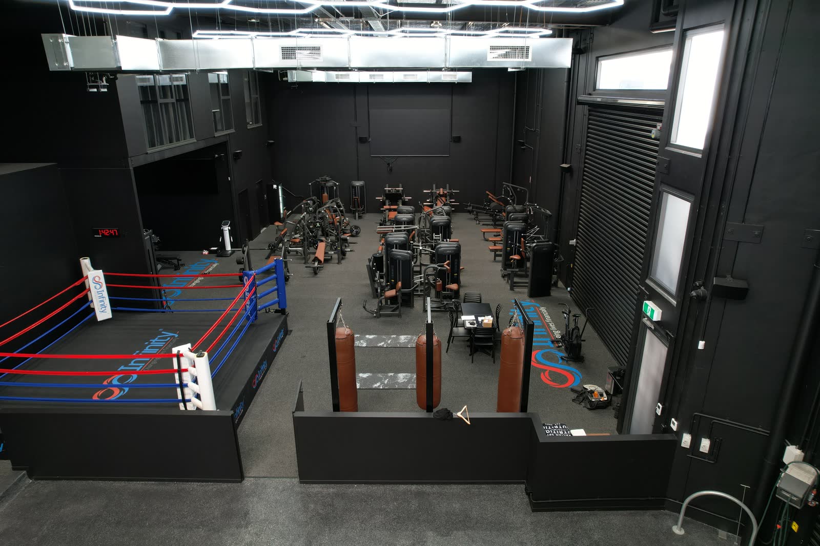 Graeme Holm’s floor from above: the boxing ring, rows of machines and the Infinity Group logo on the floor